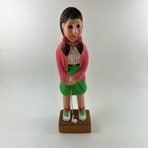 Vintage hand-carved wooden figurine of a female golf player